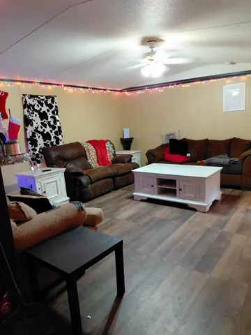 a living room with furniture and a chandelier