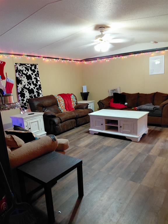 10855 Winrock Road Mooringsport, LA 71060 - Photo 9 of 21 a living room with furniture and a chandelier