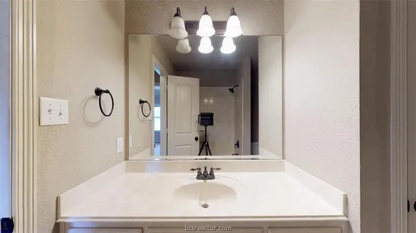a bathroom with a sink and a mirror