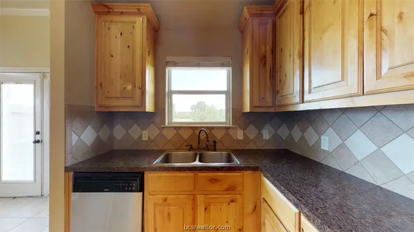 a kitchen with stainless steel appliances granite countertop a sink and a cabinets