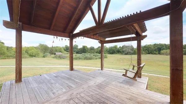 a view of a deck with a ocean from a balcony