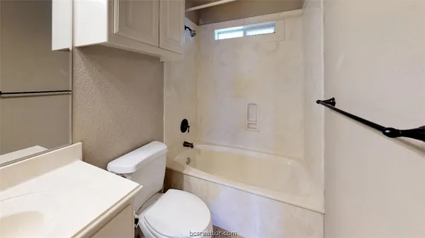a white toilet sitting next to a bath tub