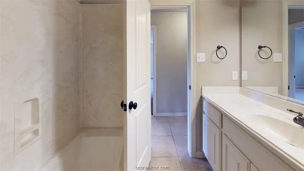 a bathroom with a sink and mirror