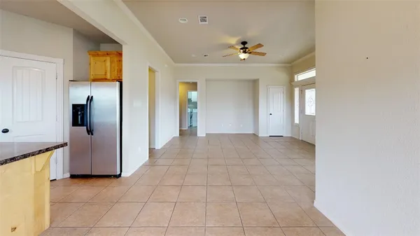 an empty room with chandelier fan