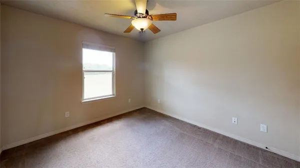 a view of an entryway with a chandelier fan and windows