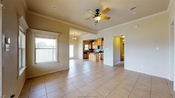 a view of a livingroom with a chandelier furniture and a kitchen
