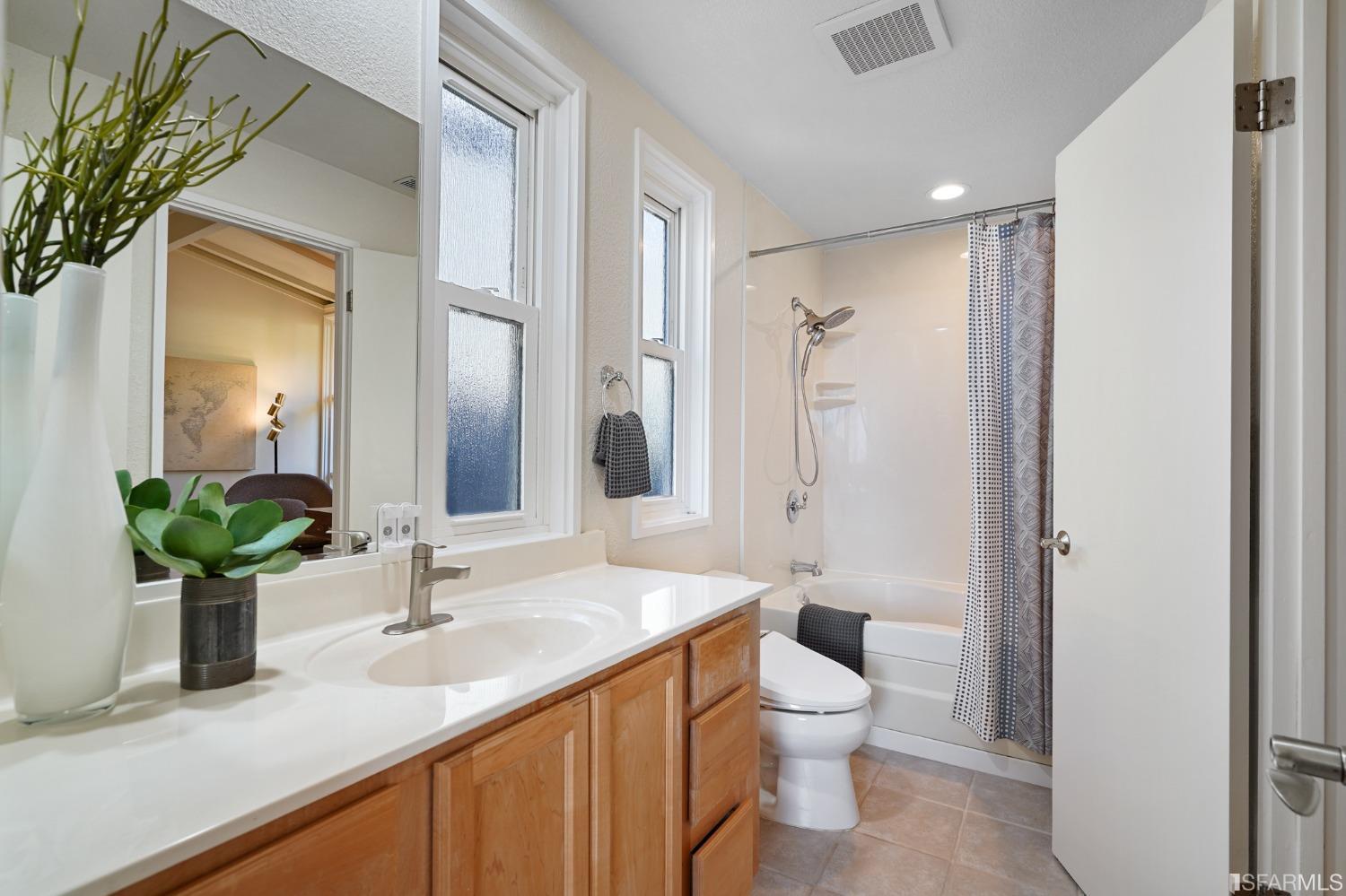 31 Avenida Drive Berkeley, CA 94708 - Photo 19 of 32 a bathroom with a granite countertop sink a toilet and a large mirror