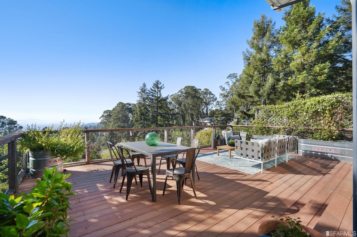 31 Avenida Drive Berkeley, CA 94708 - Photo 8 of 32 a view of a patio with table and chairs and potted plants with wooden floor and fence