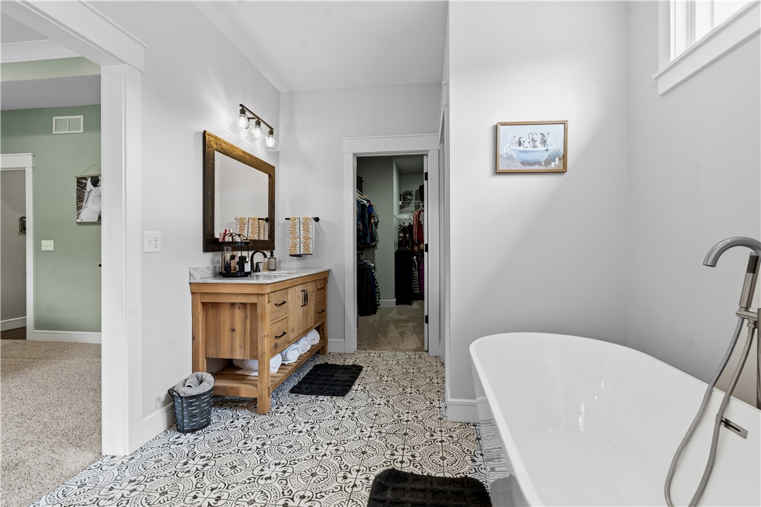 1158 Pyle Road Clarksville, OH 45113 - Photo 32 of 76 This spacious bathroom boasts a freestanding tub and a stylish vanities with ample storage.