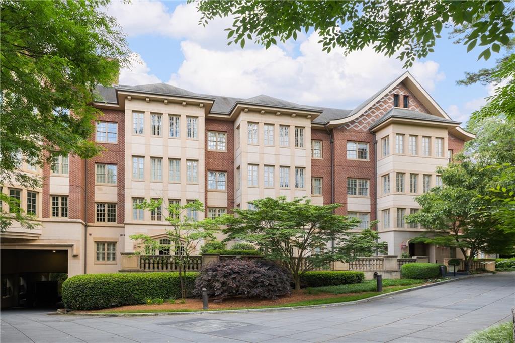 1717 North Decatur Road, Unit 204 Atlanta, GA 30307 - Photo 1 of 1 a front view of a residential apartment building with a yard and parking space