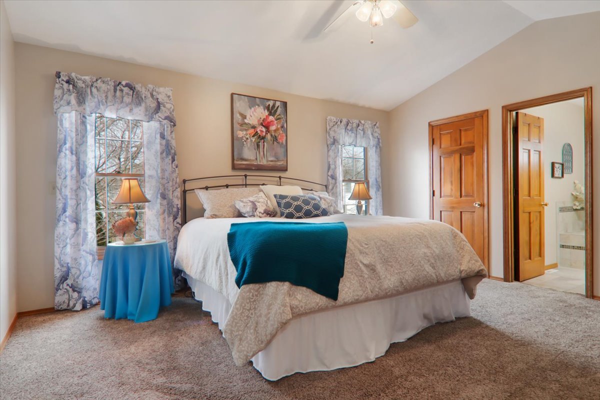 8 Minks Court Bloomington, IL 61704 - Photo 17 of 40 a bedroom with a bed and a chandelier