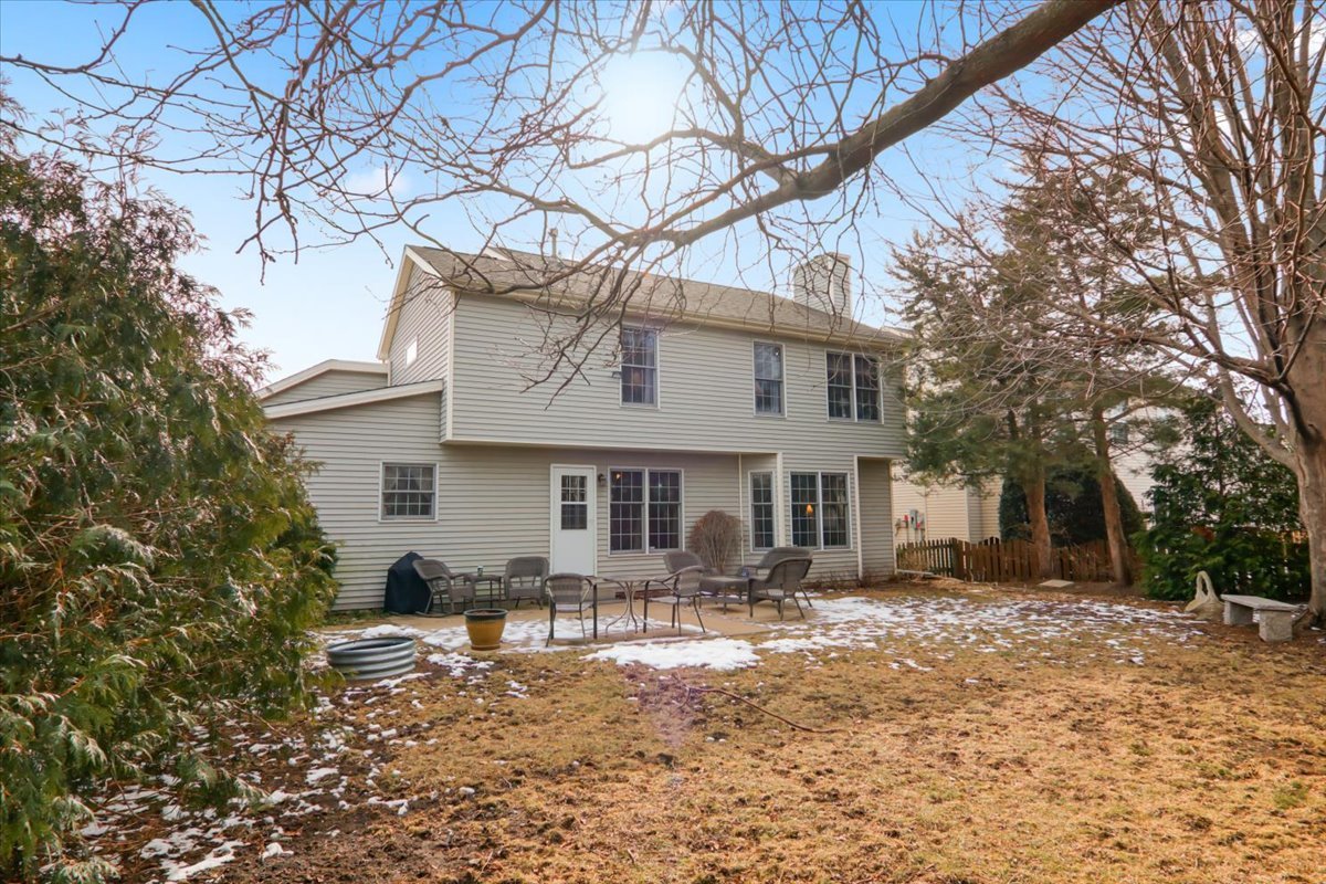 8 Minks Court Bloomington, IL 61704 - Photo 32 of 40 a front view of house with yard outdoor seating and covered with trees