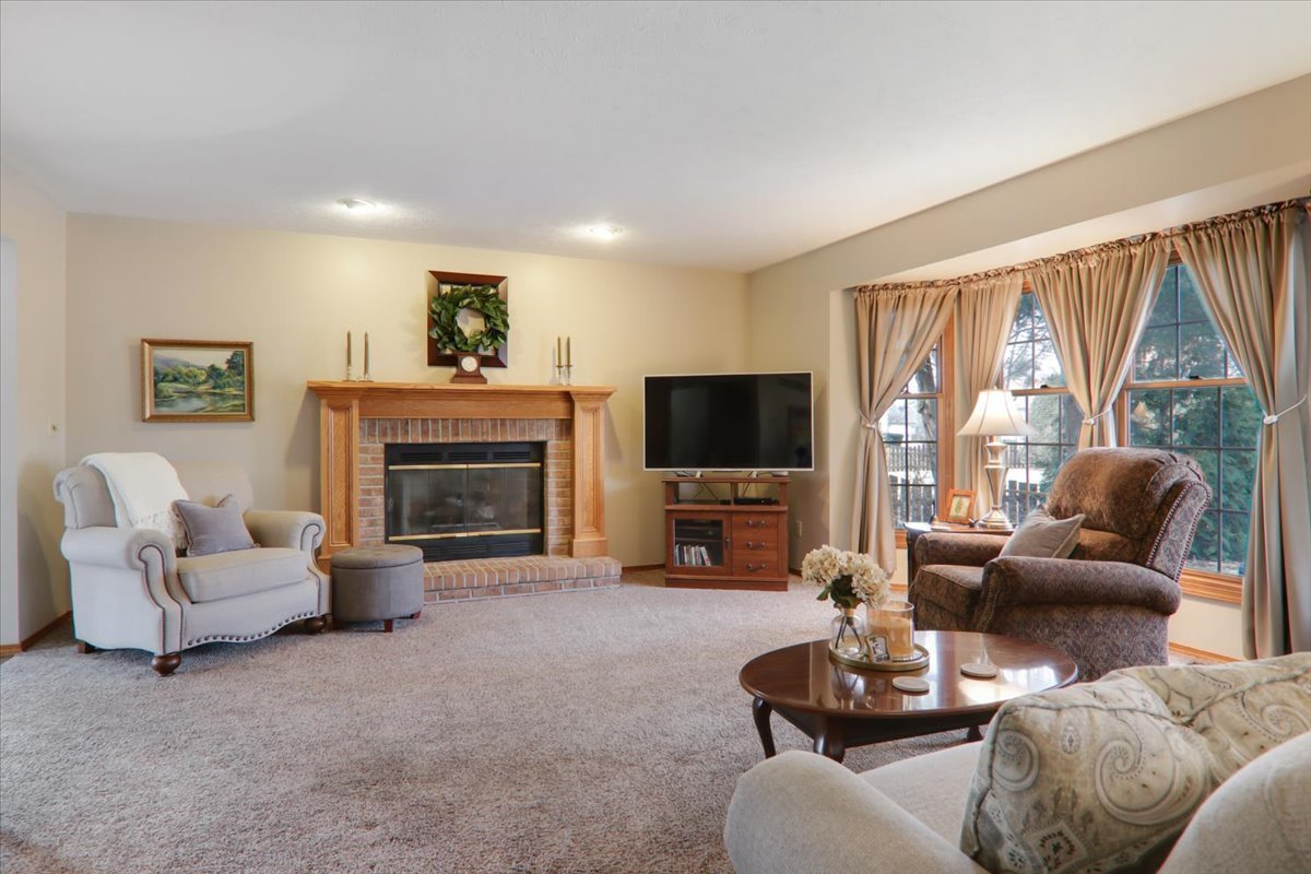 8 Minks Court Bloomington, IL 61704 - Photo 7 of 40 a living room with furniture a large window and a fireplace