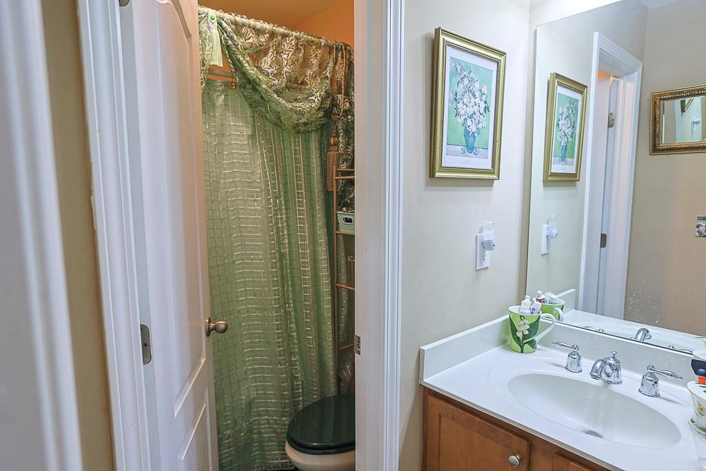 300 Hampton Place Canton, GA 30115 - Photo 36 of 82 a bathroom with a sink a mirror and a shower