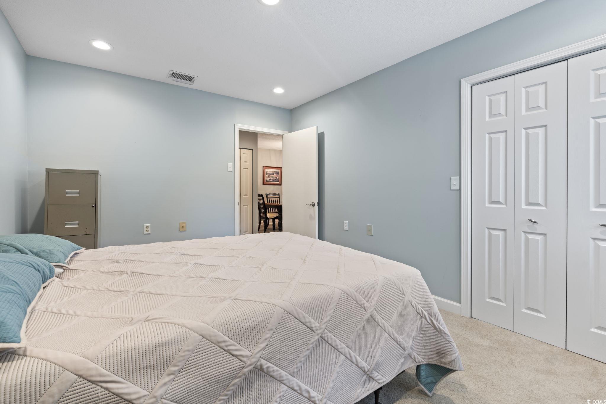 5001 Little River Road, Unit W102 Myrtle Beach, SC 29577 - Photo 24 of 38 Bedroom with light colored carpet, recessed lighting, and a closet