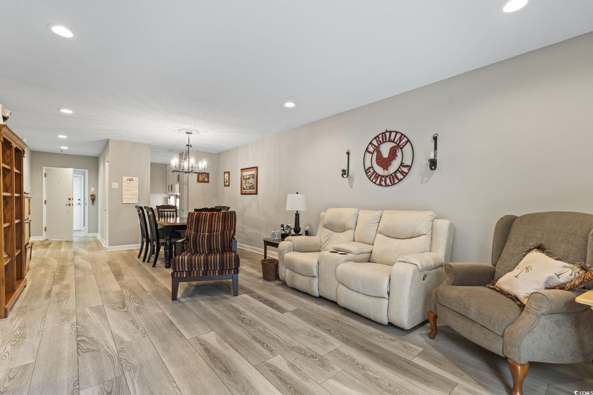 5001 Little River Road, Unit W102 Myrtle Beach, SC 29577 - Photo 4 of 38 Living room with light wood-style flooring, a chandelier, and recessed lighting