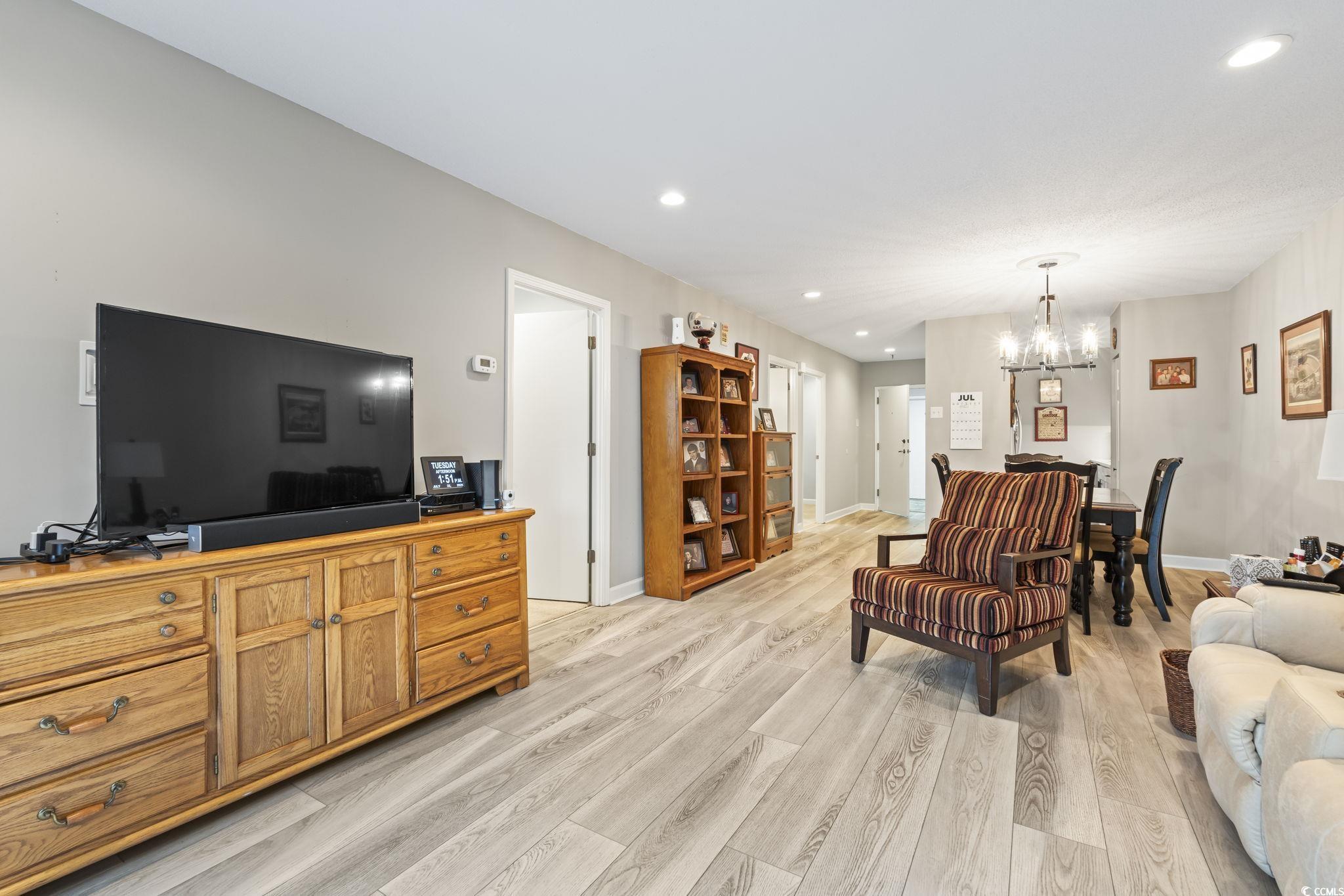 5001 Little River Road, Unit W102 Myrtle Beach, SC 29577 - Photo 5 of 38 Living area featuring a chandelier, recessed lighting, and light wood finished floors