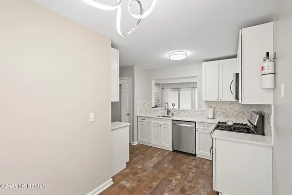 a kitchen with granite countertop a sink and a stove top oven
