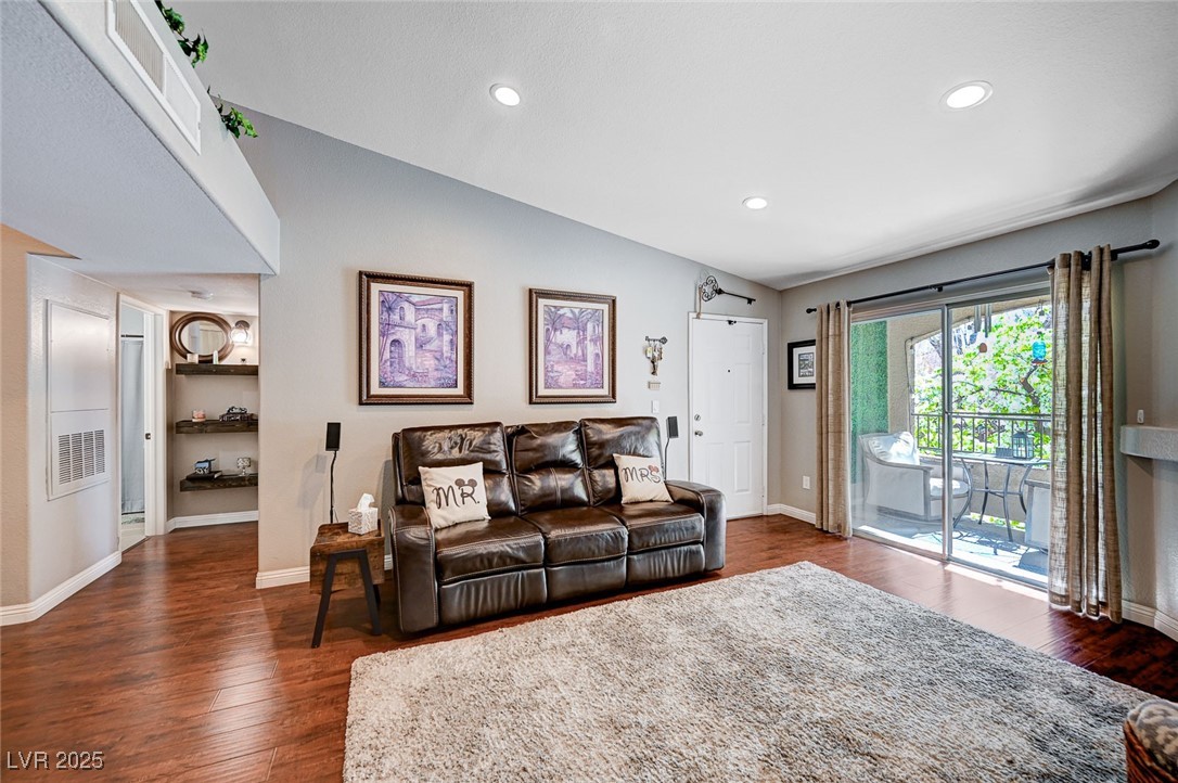 7885 West Flamingo Road, Unit 2023 Las Vegas, NV 89147 - Photo 3 of 34 Living area featuring lofted ceiling, recessed lighting, wood finished floors, and baseboards