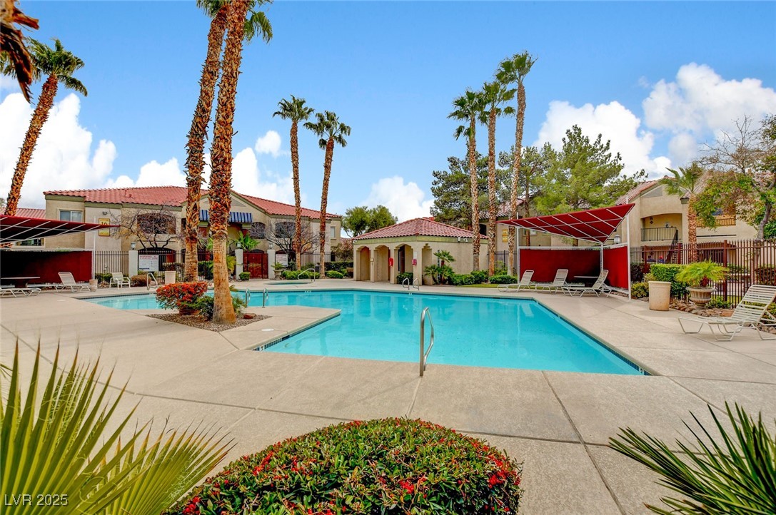 7885 West Flamingo Road, Unit 2023 Las Vegas, NV 89147 - Photo 33 of 34 Community pool with a patio and fence