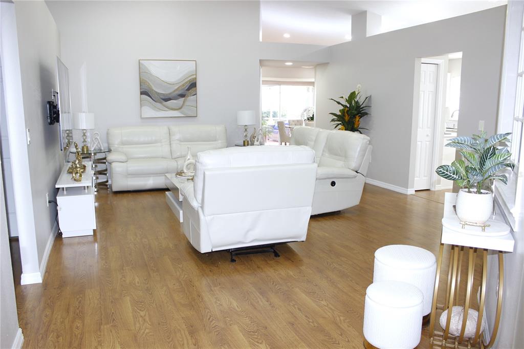 13451 Knotty Lane Hudson, FL 34669 - Photo 12 of 34 a living room with furniture and a wooden floor