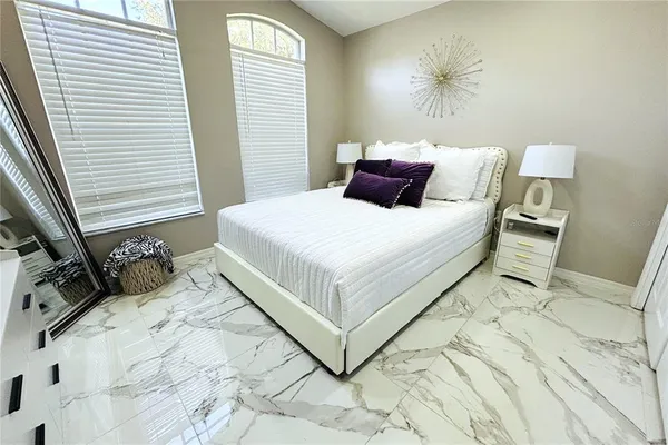 a bedroom with bed and a window