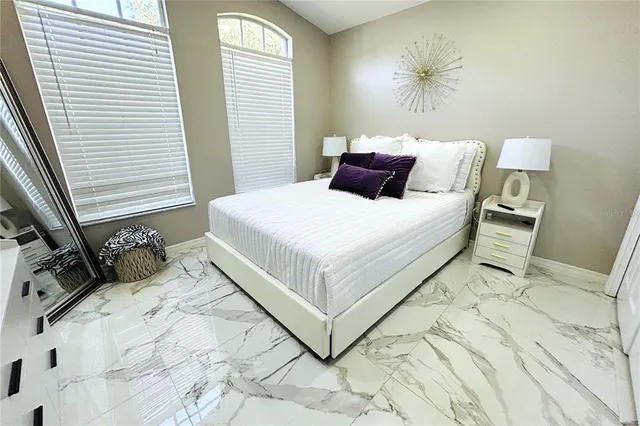 a bedroom with bed and a window