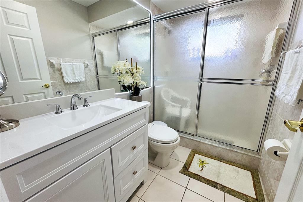 13451 Knotty Lane Hudson, FL 34669 - Photo 20 of 34 a bathroom with a sink toilet and shower