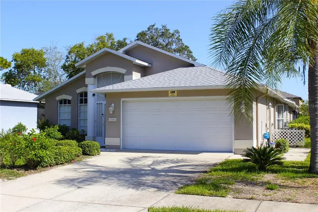 a front view of a house with a yard and a garage