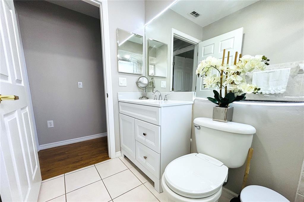 13451 Knotty Lane Hudson, FL 34669 - Photo 21 of 34 a bathroom with a toilet sink and mirror