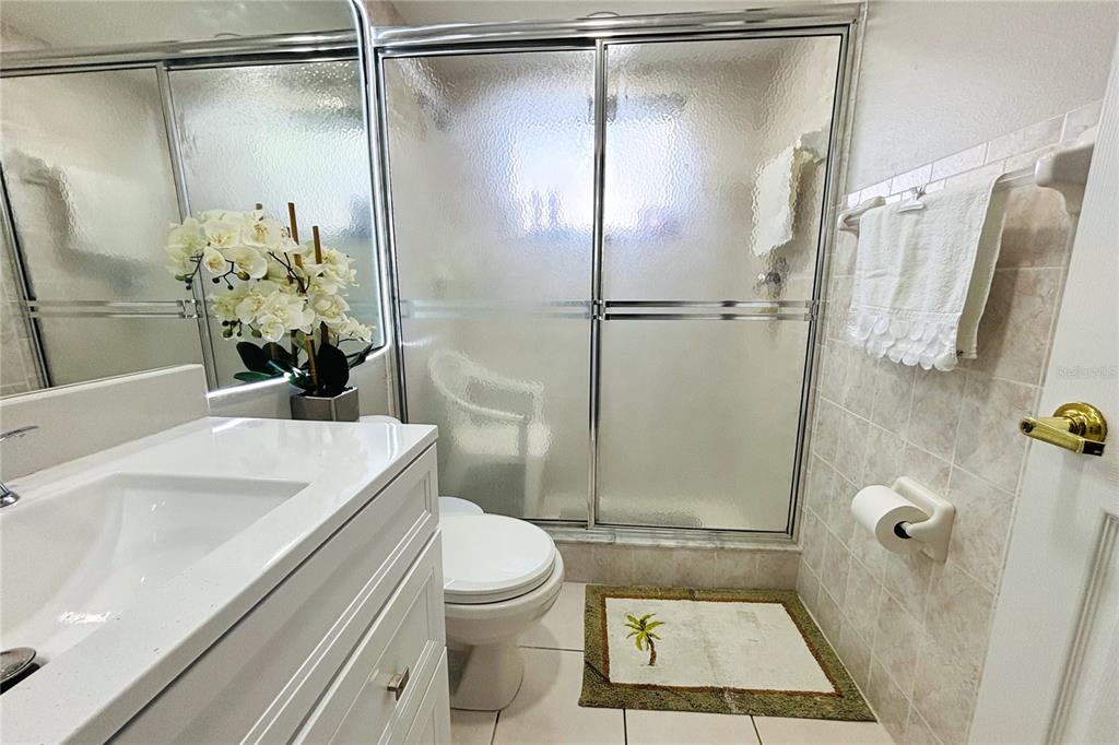 13451 Knotty Lane Hudson, FL 34669 - Photo 22 of 34 a bathroom with a sink toilet and shower