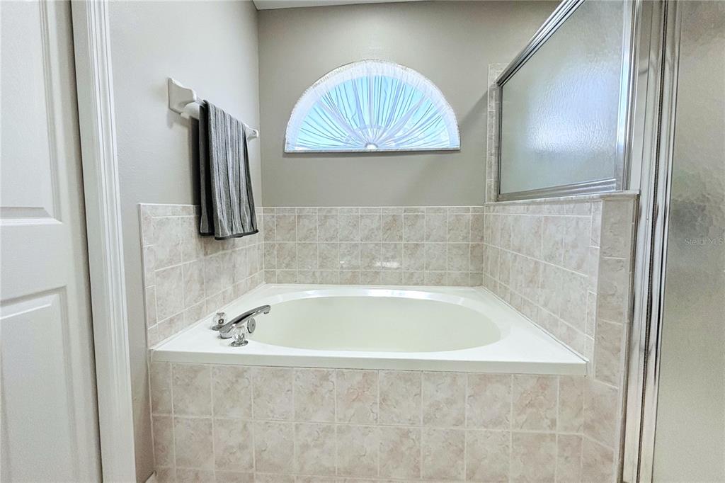 13451 Knotty Lane Hudson, FL 34669 - Photo 24 of 34 a bath tub sitting next to a bathroom sink