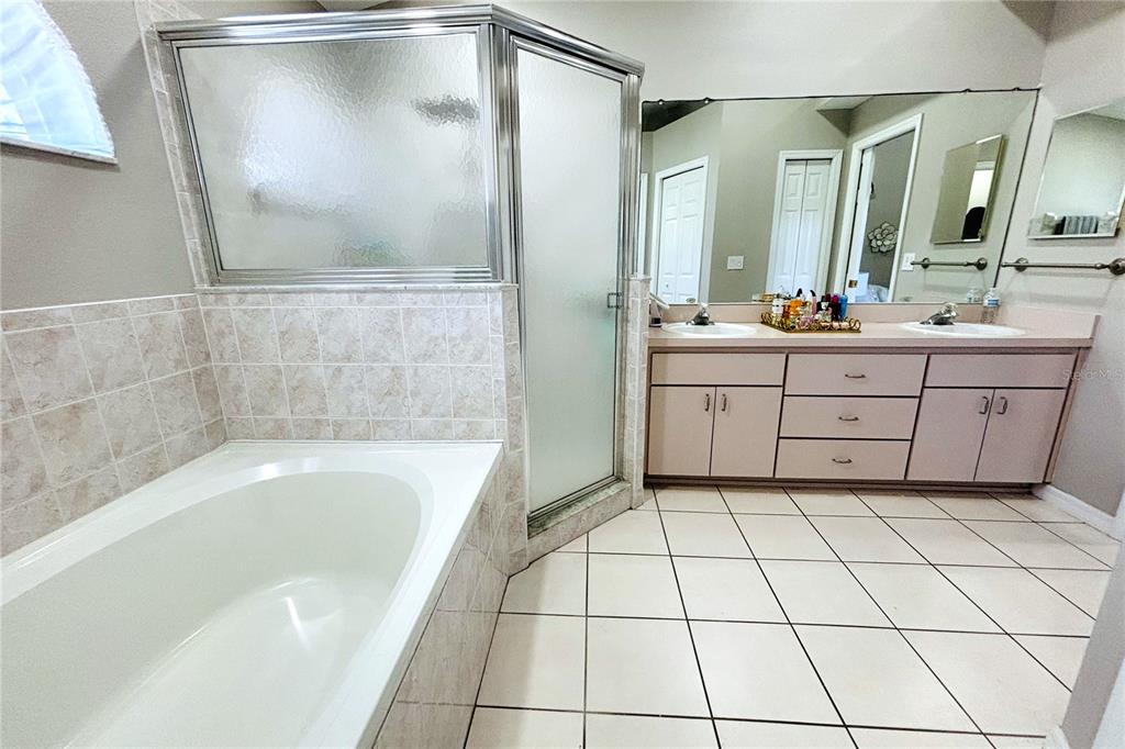 13451 Knotty Lane Hudson, FL 34669 - Photo 25 of 34 a bathroom with a bathtub and a sink