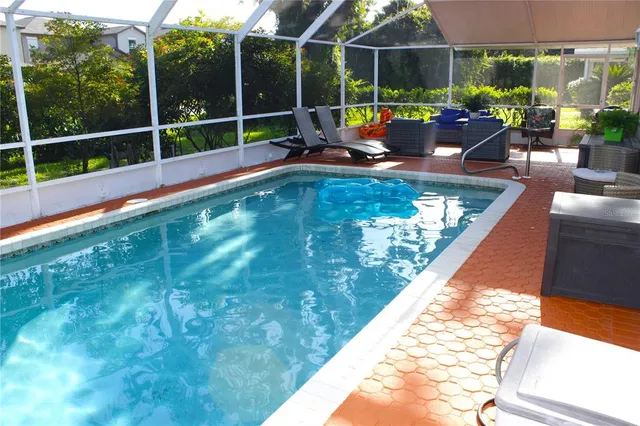a view of swimming pool with outdoor seating