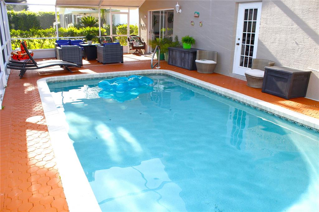13451 Knotty Lane Hudson, FL 34669 - Photo 29 of 34 a view of swimming pool with outdoor seating