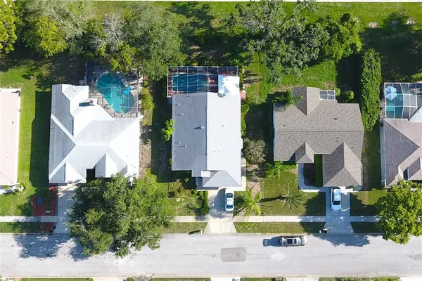 an aerial view of residential houses with outdoor space
