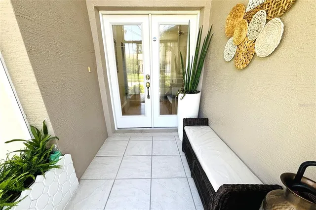 a dining room with furniture potted plants and wooden floor