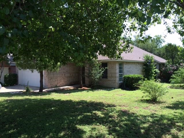 12901 Withers Way Austin, TX 78727 - Photo 1 of 13 a front view of a house with a yard and tree