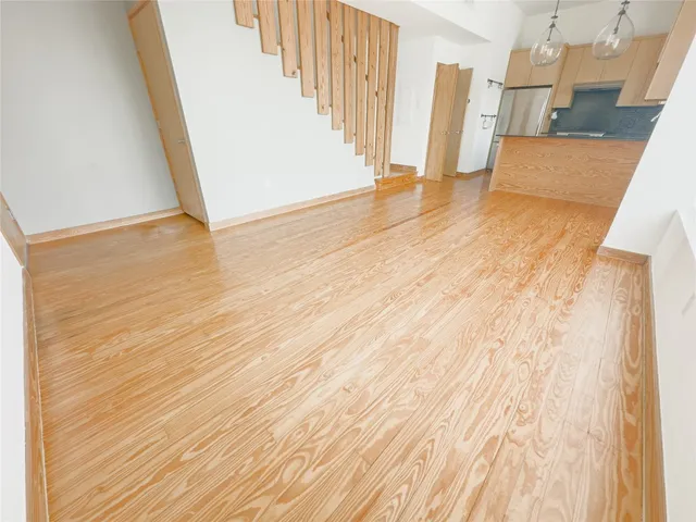 a view of a kitchen with wooden floor