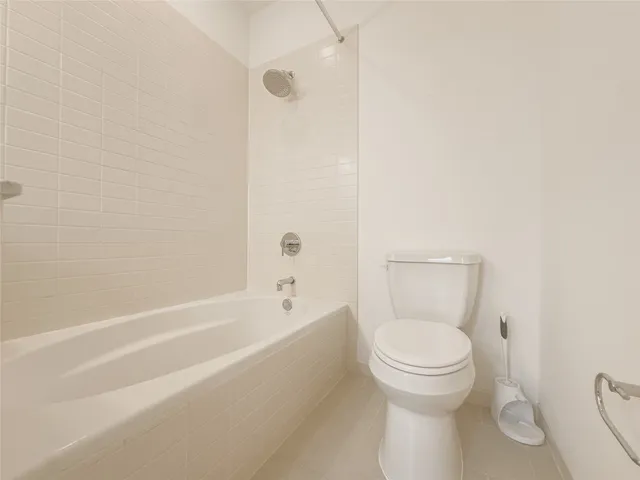 a bathroom with a toilet and a bath tub
