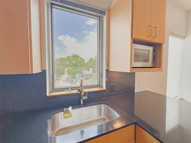 a kitchen with sink refrigerator and cabinets