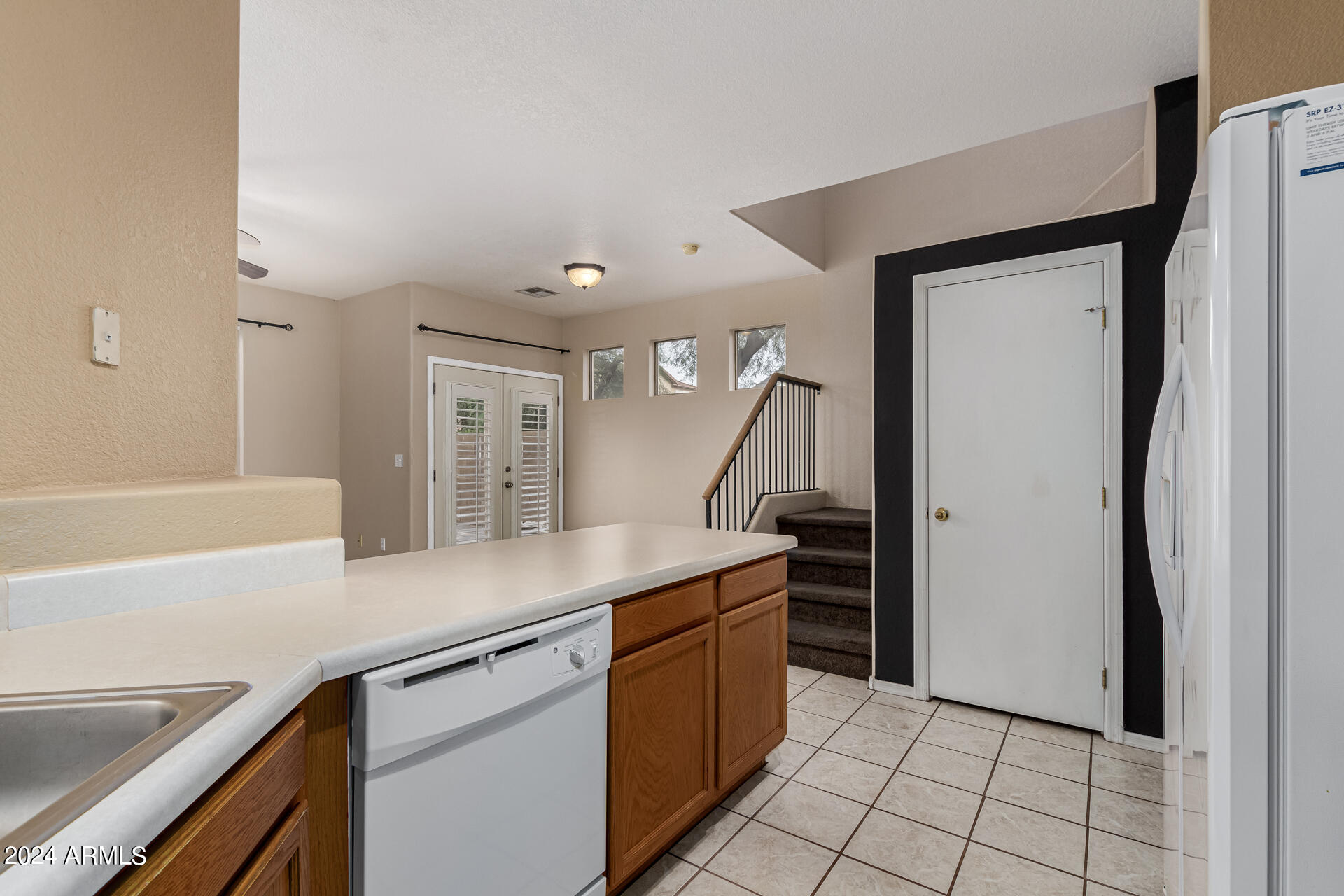 1371 South Boulder Street, Unit A Gilbert, AZ 85296 - Photo 17 of 43 a kitchen with stainless steel appliances a sink and a refrigerator