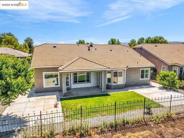 a front view of a house with garage and garden