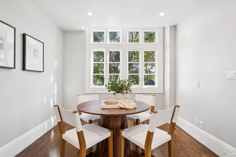 a living room with furniture and floor to ceiling windows