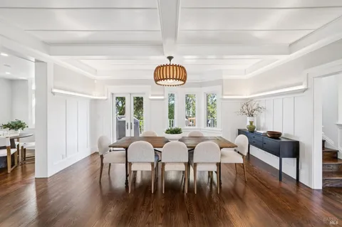 a living room with furniture and floor to ceiling windows