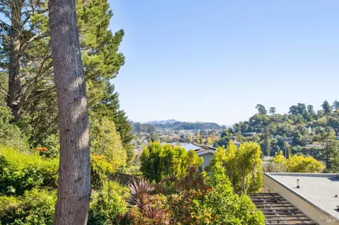 a bedroom with a bed a table and a dresser