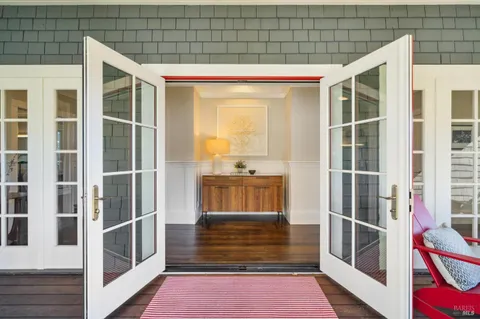 a living room with furniture potted plant and a large window