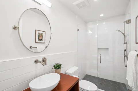 a kitchen with stainless steel appliances granite countertop a stove a sink dishwasher and microwave with wooden floor