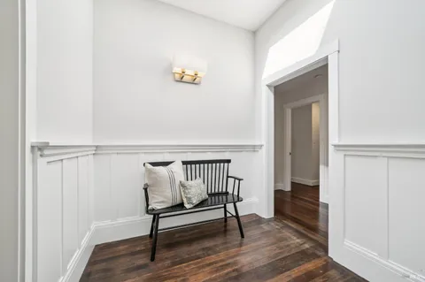 a bathroom with a granite countertop sink and a window