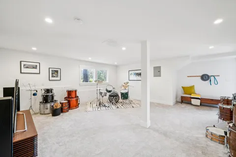 a dining room with wooden floor and a chandelier